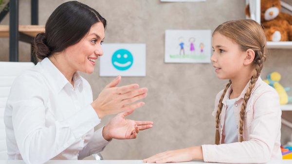 smiling-portrait-girl-female-psychologist-having-conversation-office